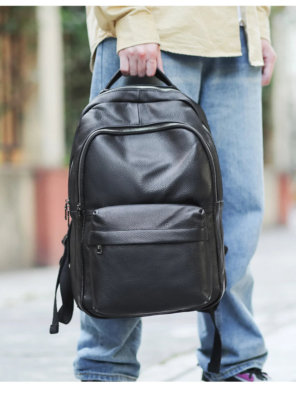 Mens Student Leather Backpack in hand
